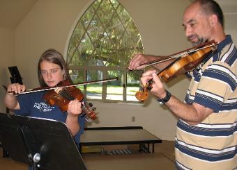 giving a violin lesson